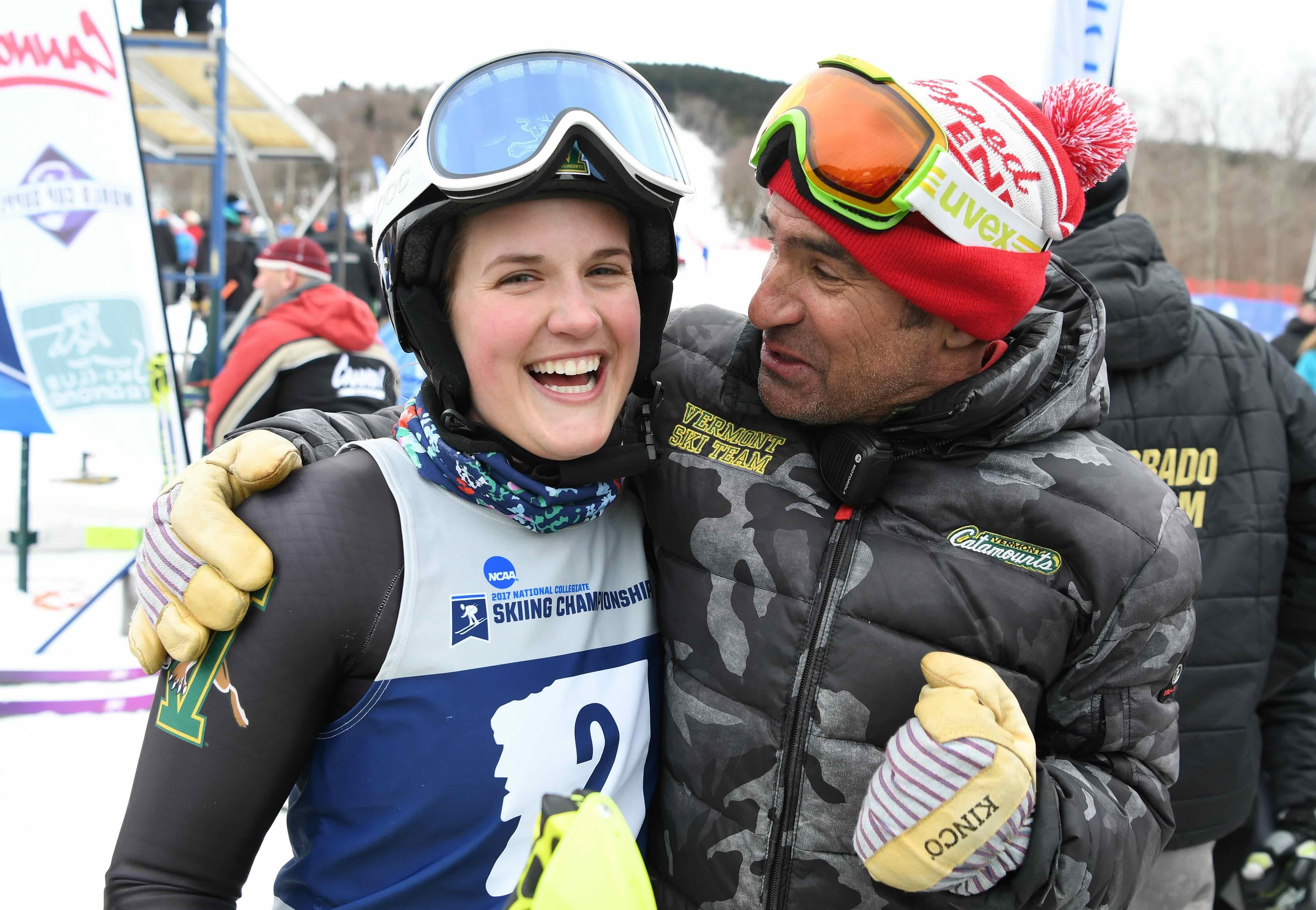 Vermont coach Fred Fayette congratulates Paula Moltzan after she won the women's slalom event at the Division I Men's and Women's Skiing Championships.